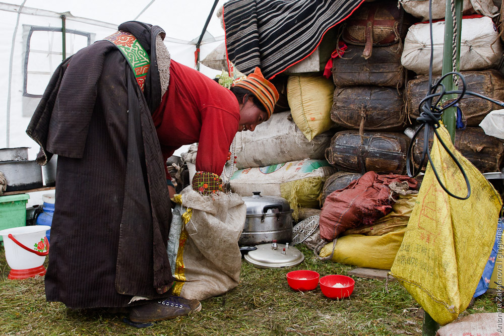 тибетская женщина-кочевница накладывает в миски цампу